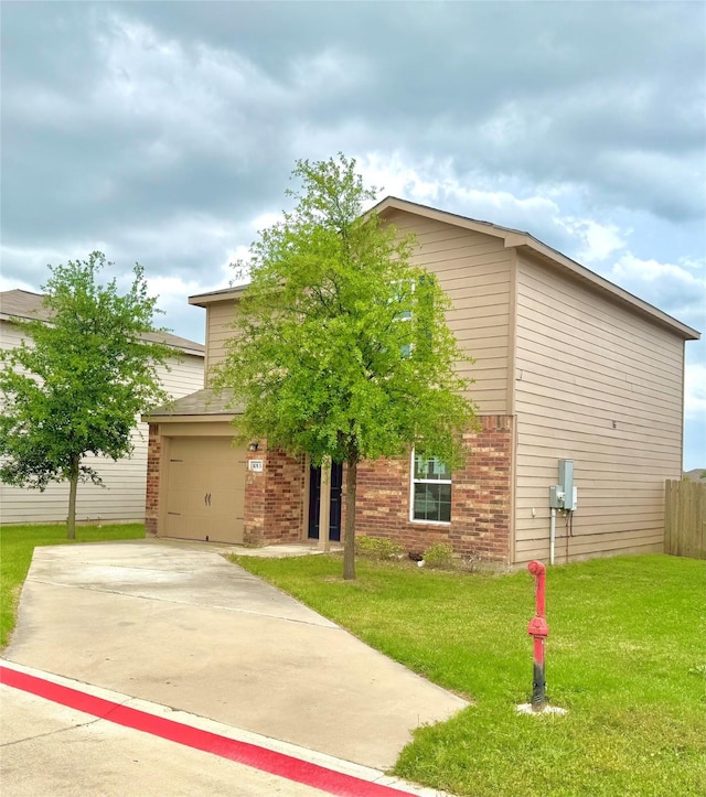 view of front of house featuring brick siding, driveway, fence, and a front yard