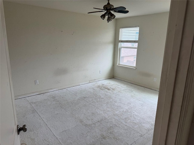 empty room with baseboards and ceiling fan