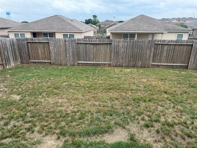 view of yard with a fenced backyard