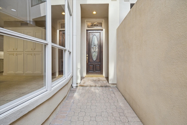 entrance to property featuring stucco siding