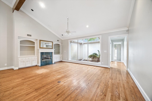 unfurnished living room with a ceiling fan, visible vents, built in features, baseboards, and light wood-style flooring
