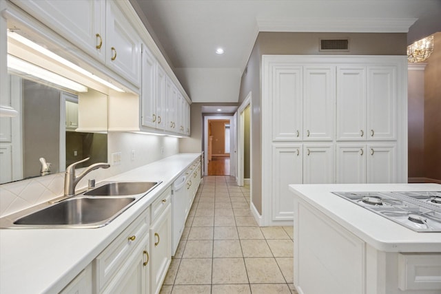 kitchen featuring a sink, white appliances, light countertops, white cabinetry, and visible vents
