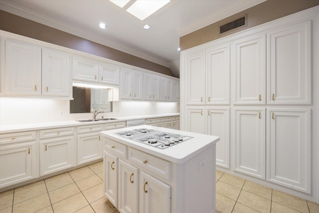 kitchen with visible vents, crown molding, a sink, light tile patterned floors, and white gas cooktop