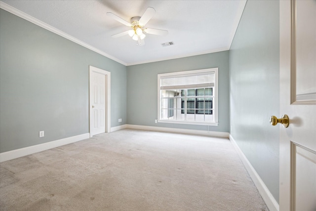 spare room featuring crown molding, baseboards, carpet, and visible vents
