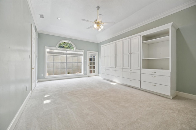 unfurnished bedroom featuring light colored carpet, ornamental molding, and baseboards