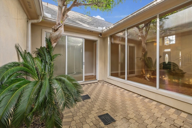 exterior space featuring a patio, visible vents, and stucco siding