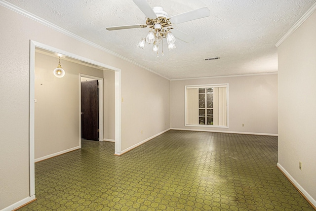 spare room featuring baseboards, a textured ceiling, and visible vents