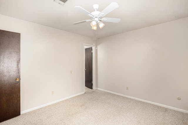 empty room with a ceiling fan, baseboards, visible vents, and light carpet