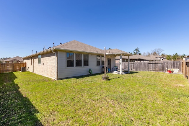 15727 Ty Cobb Ct, Splendora, TX 77372 - rear view of house featuring a lawn, a fenced backyard, and central AC unit