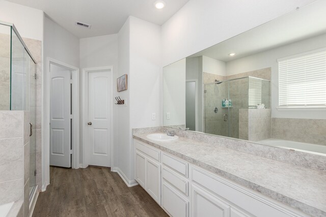 15727 Ty Cobb Ct, Splendora, TX 77372 - full bathroom with visible vents, a shower stall, wood finished floors, vanity, and recessed lighting