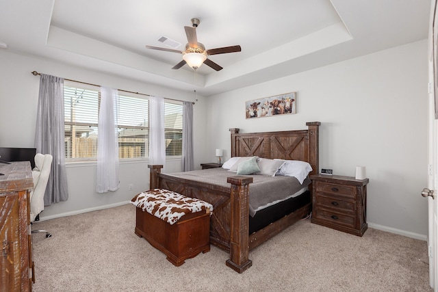 15727 Ty Cobb Ct, Splendora, TX 77372 - bedroom with light colored carpet, a raised ceiling, a ceiling fan, baseboards, and visible vents