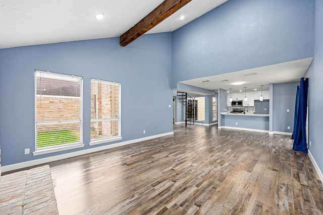 unfurnished living room featuring dark wood finished floors, beam ceiling, baseboards, high vaulted ceiling, and recessed lighting