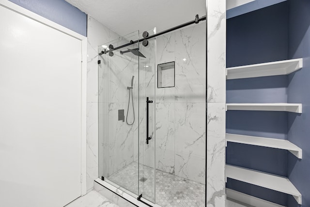 bathroom featuring a marble finish shower and marble finish floor