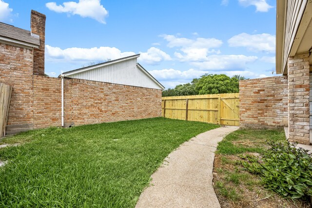 view of yard with fence and a gate