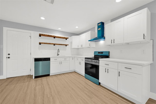kitchen with wall chimney range hood, appliances with stainless steel finishes, open shelves, a sink, and light wood-style flooring