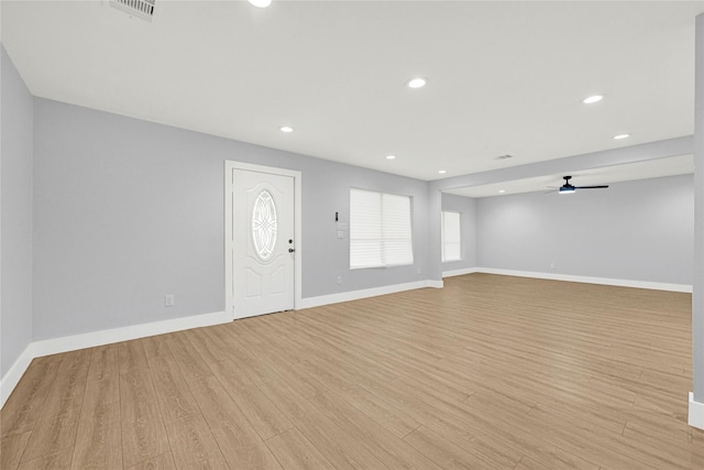 foyer featuring baseboards, visible vents, ceiling fan, and light wood-style floors
