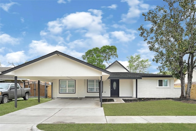 single story home with fence, a carport, driveway, and a front lawn