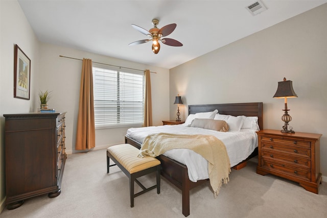 bedroom featuring baseboards, ceiling fan, light carpet, and visible vents