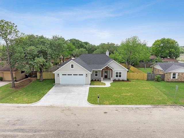 102 Tekla St, Weimar, TX 78962 - single story home with board and batten siding, concrete driveway, and a front lawn