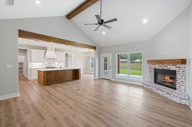 102 Tekla St, Weimar, TX 78962 - unfurnished living room featuring beamed ceiling, light wood-type flooring, high vaulted ceiling, and a fireplace