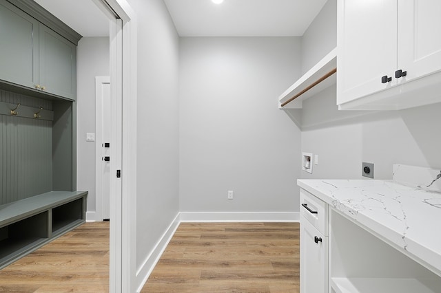 102 Tekla St, Weimar, TX 78962 - clothes washing area with cabinet space, washer hookup, light wood-style flooring, baseboards, and hookup for an electric dryer
