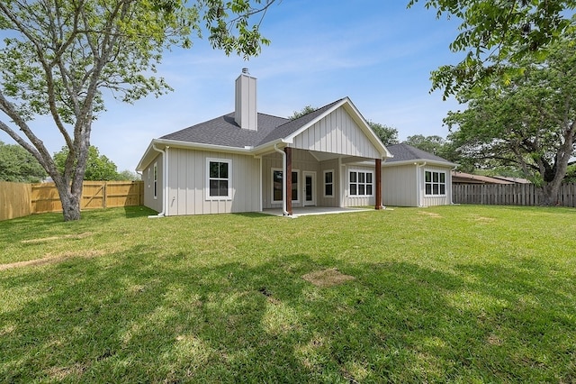 102 Tekla St, Weimar, TX 78962 - back of house featuring a fenced backyard, a patio, a chimney, and a yard