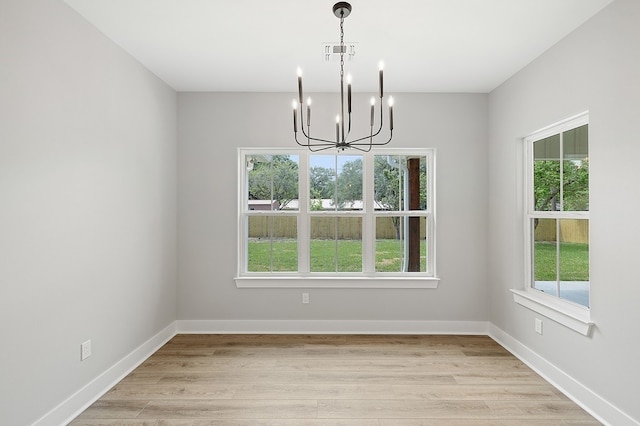 102 Tekla St, Weimar, TX 78962 - unfurnished dining area featuring visible vents, baseboards, a notable chandelier, and light wood-type flooring