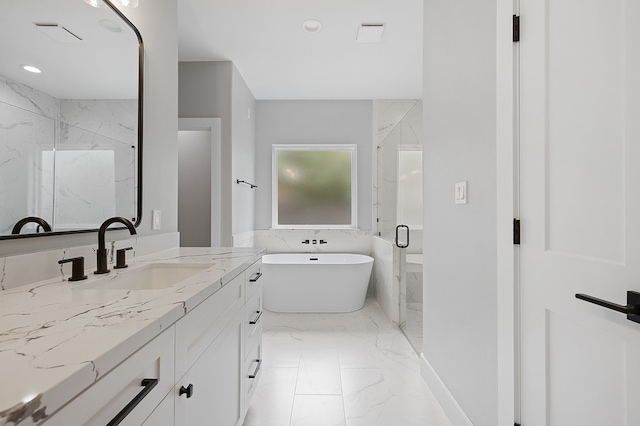 102 Tekla St, Weimar, TX 78962 - bathroom with a freestanding bath, vanity, marble finish floor, a marble finish shower, and recessed lighting