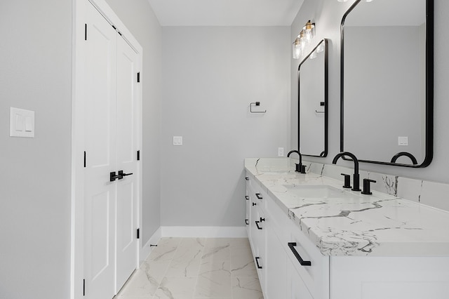 102 Tekla St, Weimar, TX 78962 - bathroom featuring baseboards, a sink, marble finish floor, and double vanity