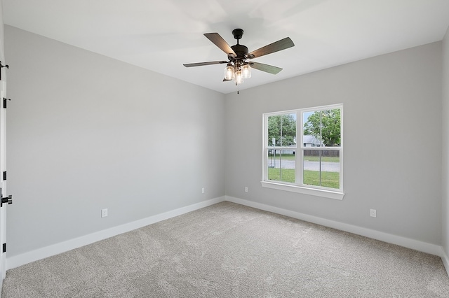 102 Tekla St, Weimar, TX 78962 - carpeted empty room with baseboards, a ceiling fan, and a barn door
