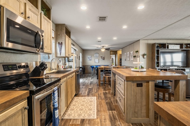620 Lagoon Dr, Point Blank, TX 77364 - kitchen featuring visible vents, dark wood finished floors, a sink, wood counters, and appliances with stainless steel finishes