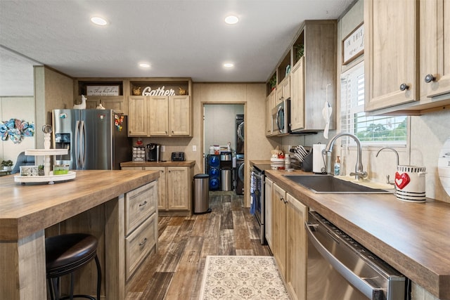 620 Lagoon Dr, Point Blank, TX 77364 - kitchen with a breakfast bar area, a sink, dark wood-style floors, wood counters, and stainless steel appliances