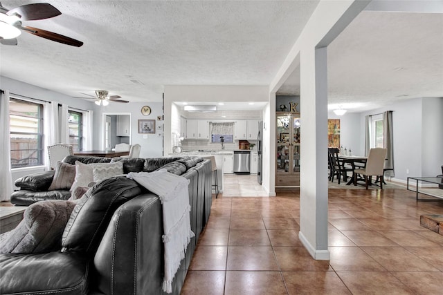 21426 Park York Dr, Katy, TX 77450 - living area featuring plenty of natural light, a ceiling fan, a textured ceiling, and light tile patterned floors