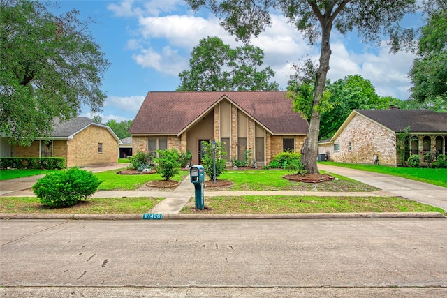 21426 Park York Dr, Katy, TX 77450 - mid-century home with roof with shingles, a front lawn, and brick siding