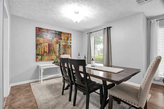 21426 Park York Dr, Katy, TX 77450 - dining space featuring visible vents, a textured ceiling, and baseboards