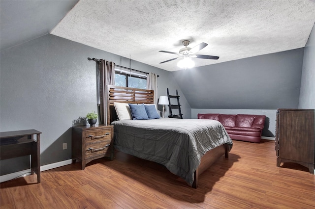 21426 Park York Dr, Katy, TX 77450 - bedroom with baseboards, vaulted ceiling, a textured wall, and wood finished floors