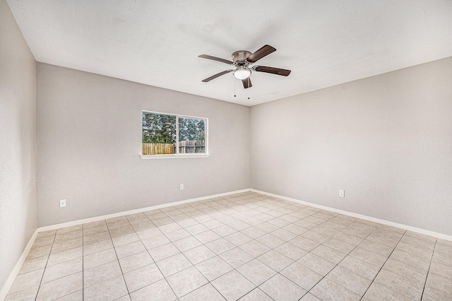 spare room featuring baseboards and a ceiling fan
