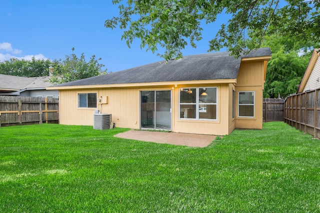 back of house featuring a lawn, a patio area, central AC, a fenced backyard, and a shingled roof
