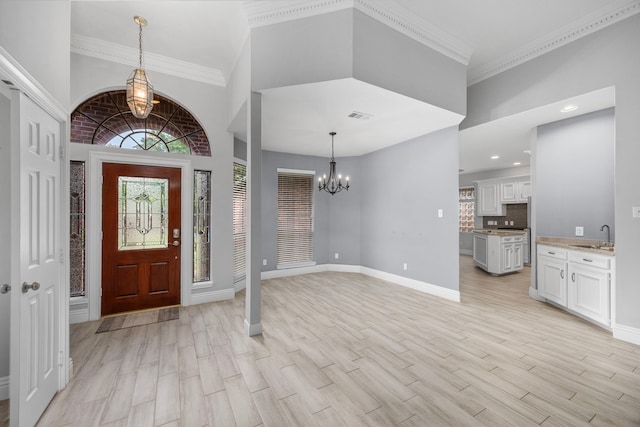 6542 Shinnecock Hills Dr, Houston, TX 77069 - foyer with a chandelier, baseboards, light wood-style flooring, recessed lighting, and crown molding