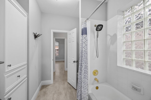 6542 Shinnecock Hills Dr, Houston, TX 77069 - bathroom with shower / bath combination with curtain and baseboards