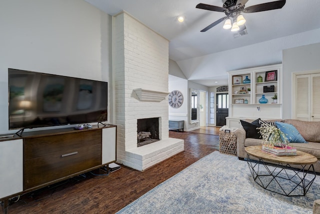 living room with ceiling fan, visible vents, a fireplace, vaulted ceiling, and wood finished floors