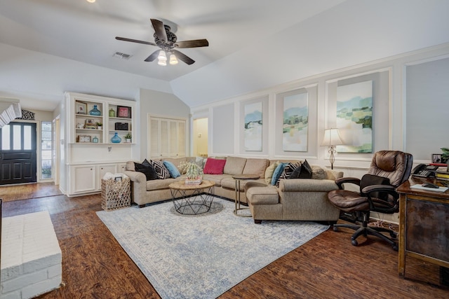 living area featuring ceiling fan, lofted ceiling, dark wood-style floors, and visible vents