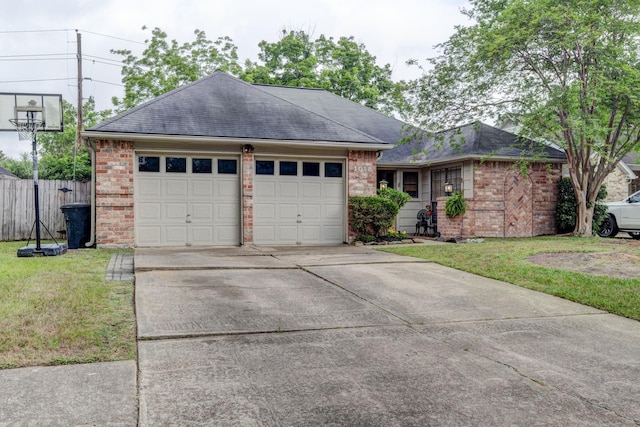 ranch-style house featuring an attached garage, a front yard, driveway, and brick siding