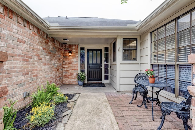 property entrance with brick siding