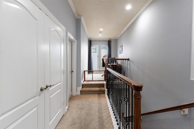 corridor featuring light colored carpet, recessed lighting, baseboards, an upstairs landing, and ornamental molding