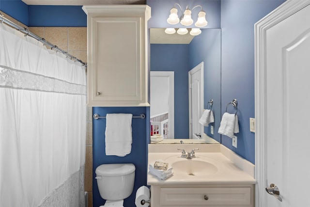 full bathroom with vanity, toilet, and curtained shower