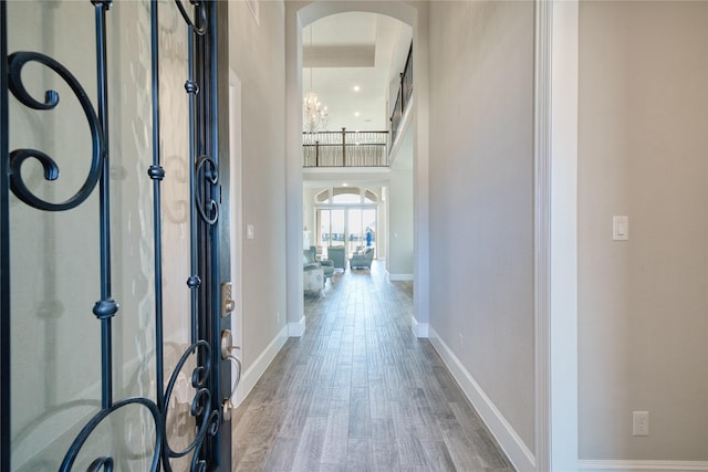 23935 Birchwood Lake Ln, Katy, TX 77493 - foyer with french doors, arched walkways, wood finished floors, baseboards, and a notable chandelier