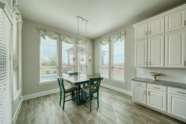 23935 Birchwood Lake Ln, Katy, TX 77493 - dining area featuring baseboards and light wood-type flooring