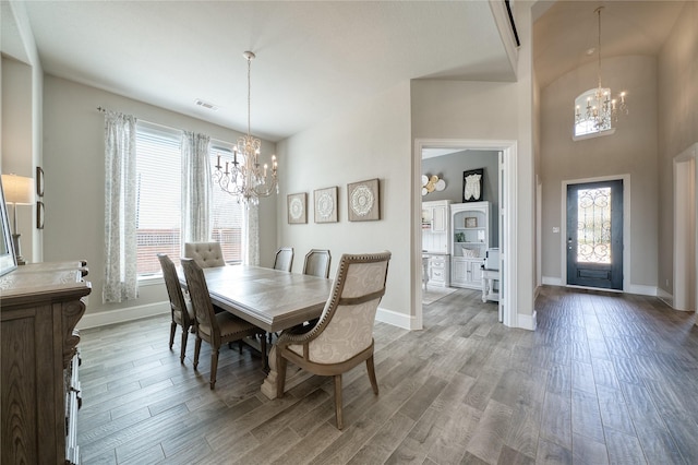 23935 Birchwood Lake Ln, Katy, TX 77493 - dining room with baseboards, a notable chandelier, a wealth of natural light, and visible vents