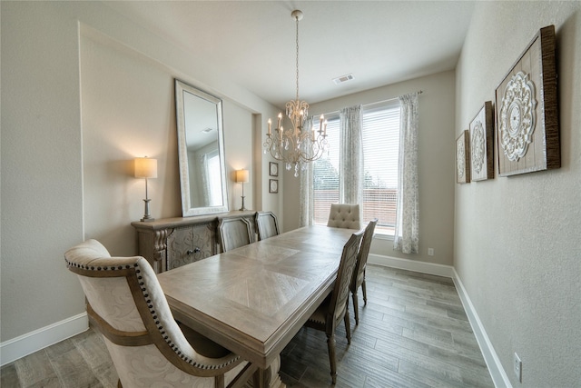 23935 Birchwood Lake Ln, Katy, TX 77493 - dining room with visible vents, baseboards, wood finished floors, and an inviting chandelier